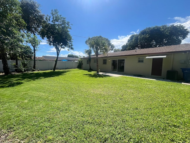 view of yard with cooling unit and a patio area