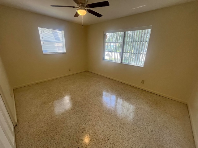 unfurnished room with a wealth of natural light and ceiling fan