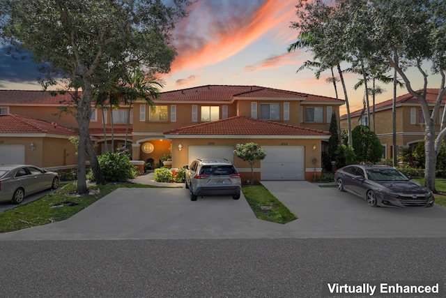 mediterranean / spanish-style home with a garage