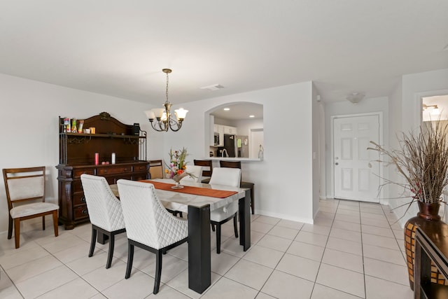 tiled dining area with an inviting chandelier