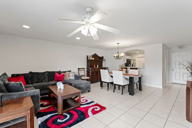 tiled living room featuring ceiling fan with notable chandelier