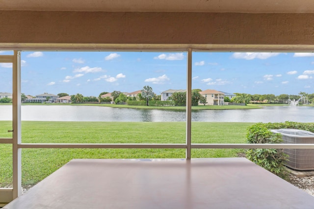 view of patio / terrace with a water view and central air condition unit