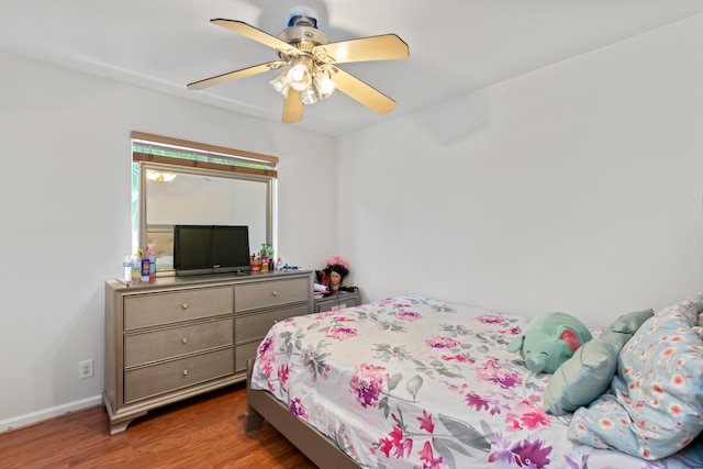 bedroom with ceiling fan and dark hardwood / wood-style floors