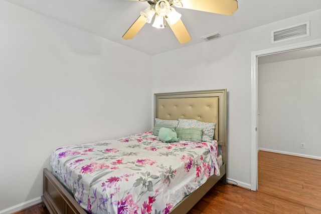 bedroom with ceiling fan and hardwood / wood-style flooring