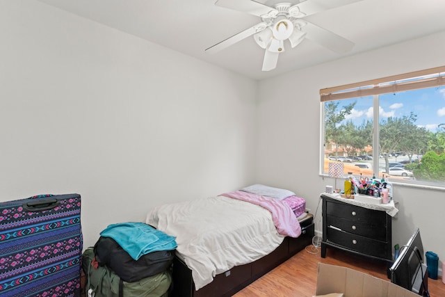 bedroom with ceiling fan and light hardwood / wood-style floors