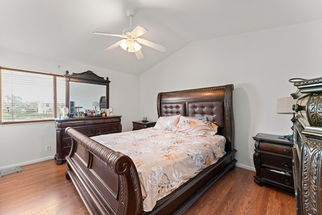 bedroom featuring vaulted ceiling, hardwood / wood-style floors, and ceiling fan