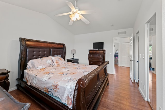 bedroom with vaulted ceiling, hardwood / wood-style floors, and ceiling fan