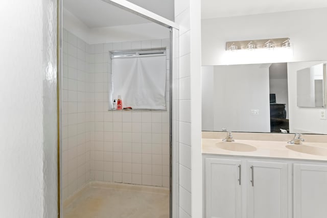 bathroom with a shower with door and vanity