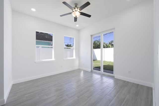 spare room with ceiling fan and light hardwood / wood-style floors