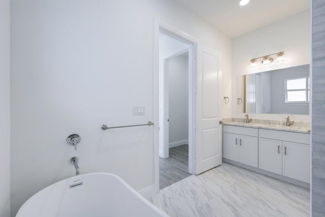 bathroom with vanity and a bath