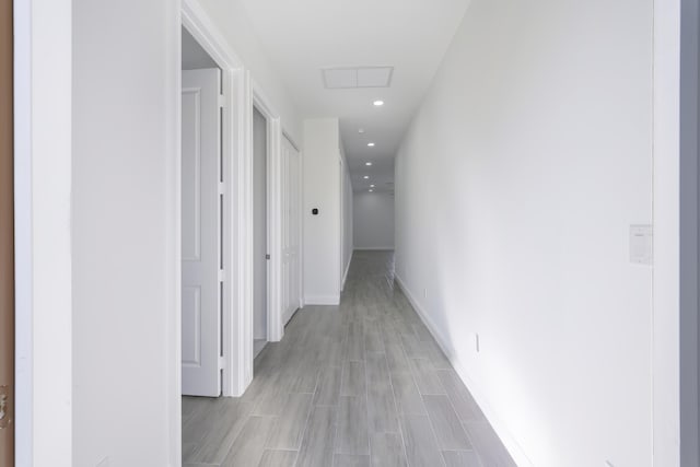 corridor with light hardwood / wood-style floors