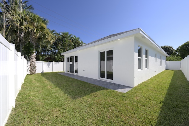 back of house with a lawn