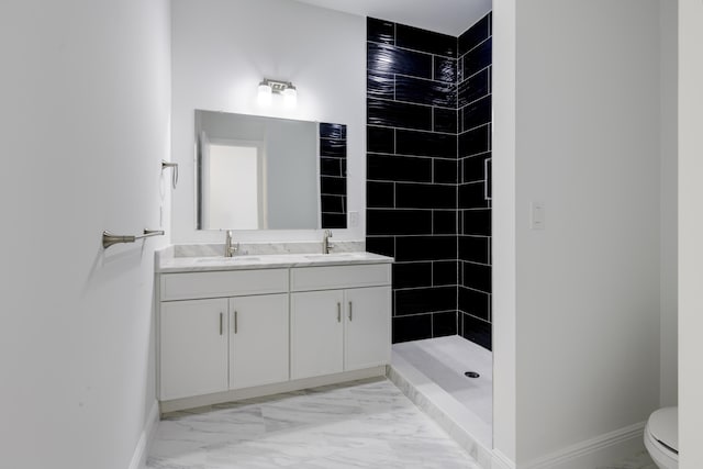 bathroom featuring tiled shower, vanity, and toilet