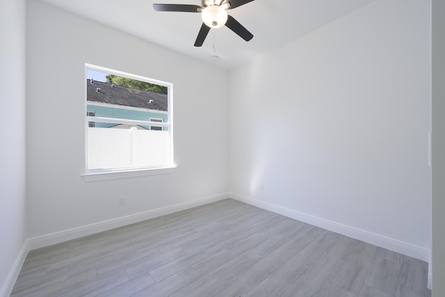 empty room with ceiling fan and light wood-type flooring