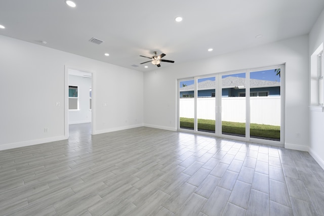 unfurnished room with ceiling fan and light wood-type flooring