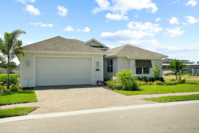 view of front of property featuring a front yard and a garage