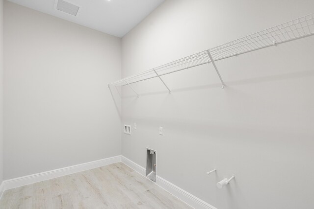 washroom with washer hookup and light hardwood / wood-style floors