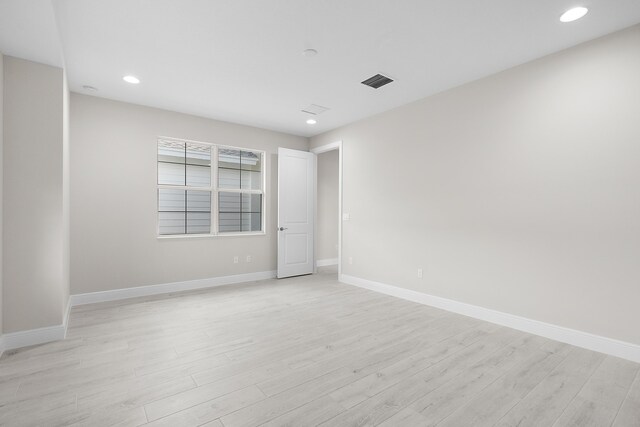 spare room featuring light hardwood / wood-style floors