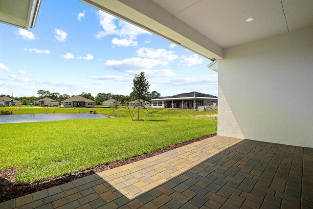 view of patio with a water view