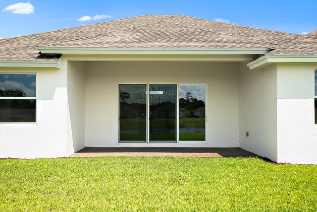 rear view of house featuring a yard