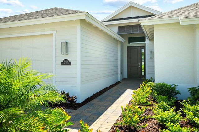 doorway to property featuring a garage