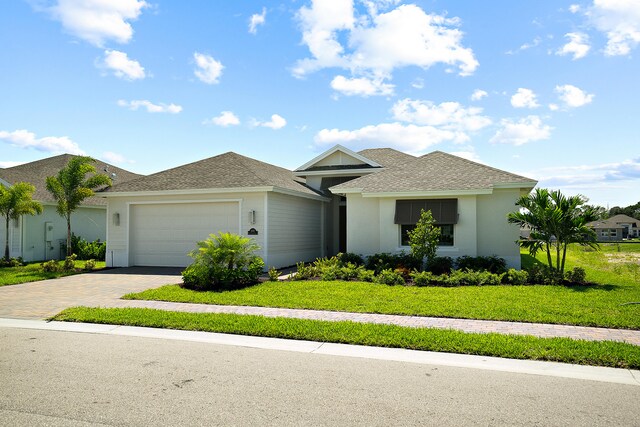 view of front of home featuring a front yard and a garage