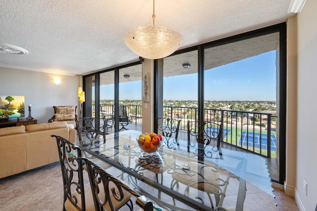 tiled dining area featuring crown molding, expansive windows, and french doors