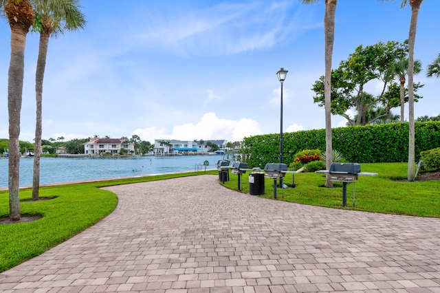 surrounding community featuring a water view and a yard