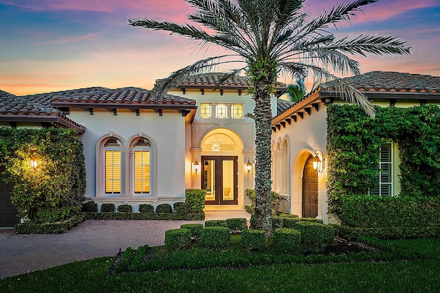 mediterranean / spanish house featuring french doors