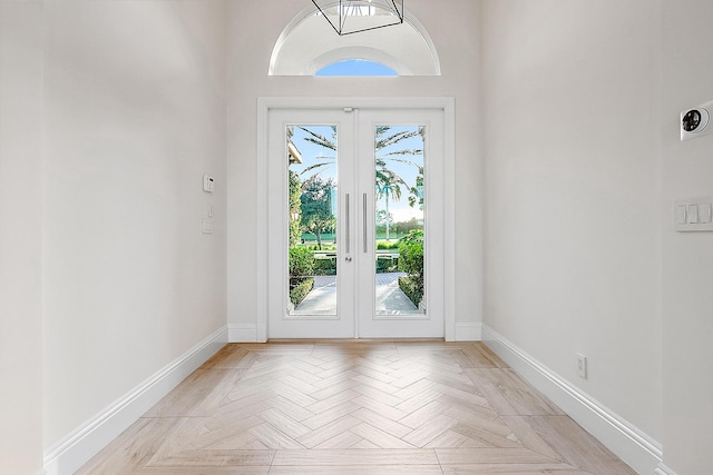 doorway to outside featuring light parquet flooring and french doors