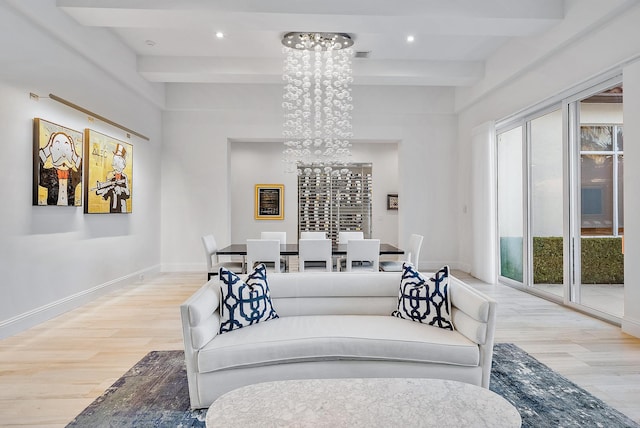 living room featuring an inviting chandelier, beam ceiling, and hardwood / wood-style floors