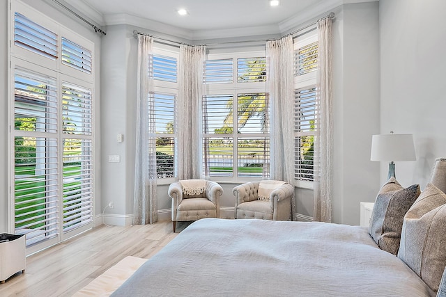 bedroom featuring crown molding, access to outside, and light hardwood / wood-style flooring