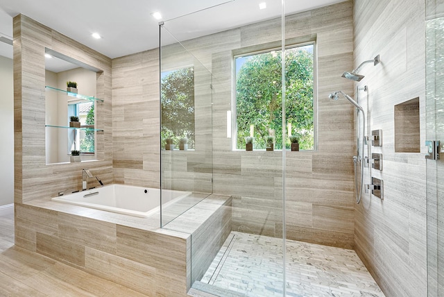 bathroom with tile walls, tile patterned flooring, and separate shower and tub