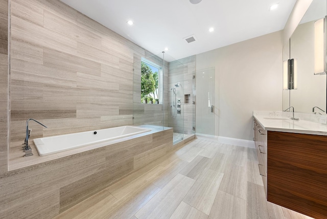 bathroom with vanity and plus walk in shower