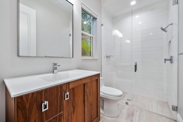 bathroom with vanity, toilet, and an enclosed shower