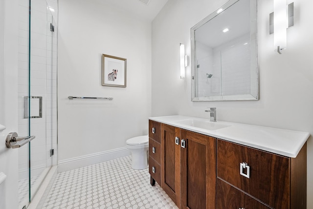 bathroom with a shower with door, vanity, and toilet