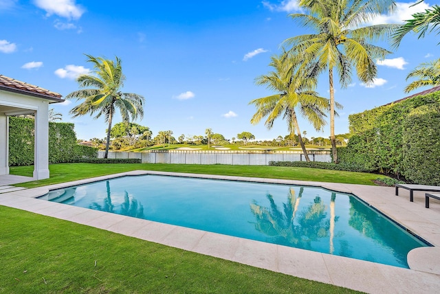 view of swimming pool with a lawn, a water view, and a patio area