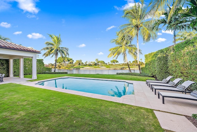 view of pool with a patio and a yard