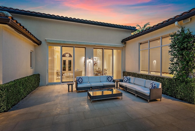 patio terrace at dusk featuring french doors and an outdoor hangout area