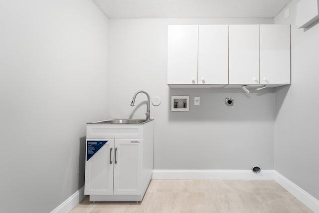 washroom with hookup for a washing machine, light hardwood / wood-style flooring, electric dryer hookup, cabinets, and sink