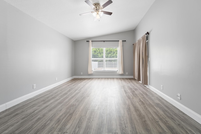 unfurnished room featuring lofted ceiling, ceiling fan, and hardwood / wood-style flooring