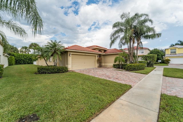 view of front of house with a garage and a front lawn