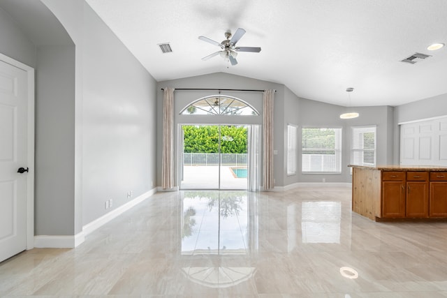 empty room with ceiling fan and vaulted ceiling