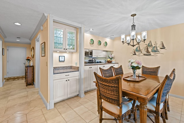 dining room featuring light tile patterned floors, an inviting chandelier, and ornamental molding