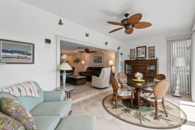 tiled dining room featuring ceiling fan and a textured ceiling