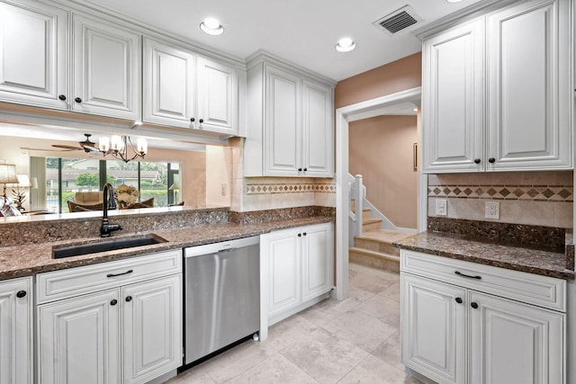 kitchen featuring white cabinetry, dishwasher, ceiling fan, sink, and dark stone counters