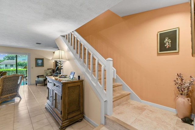 stairway with tile patterned flooring