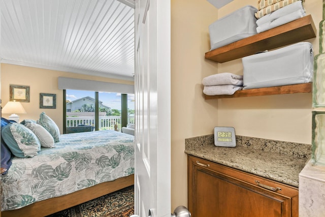 bedroom featuring access to exterior and crown molding