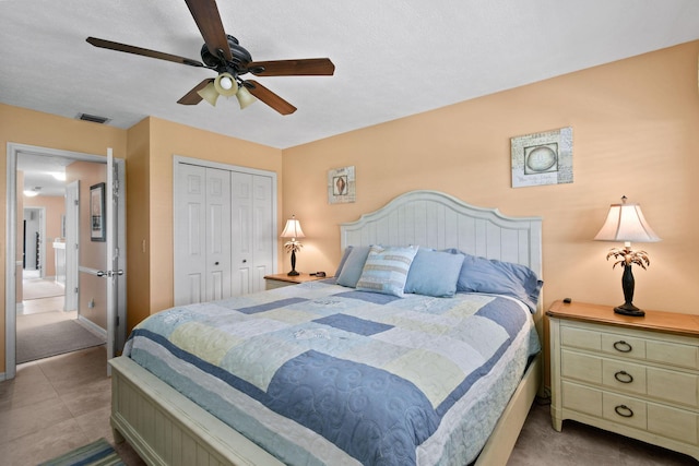 bedroom with ceiling fan, a closet, and light tile patterned flooring