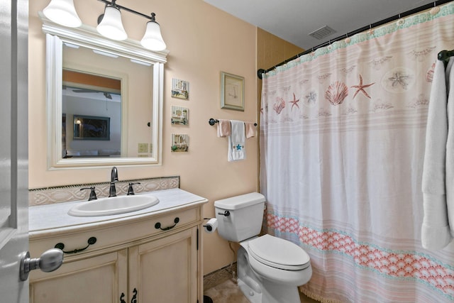 bathroom with toilet, vanity, and a shower with shower curtain